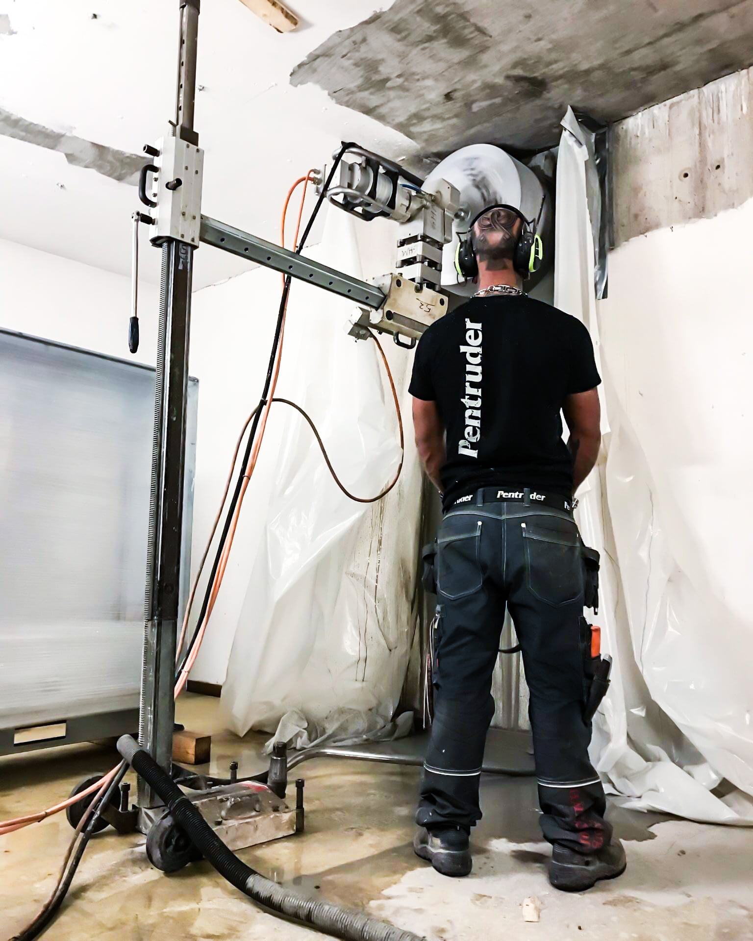 a man standing next to a core drill machine.